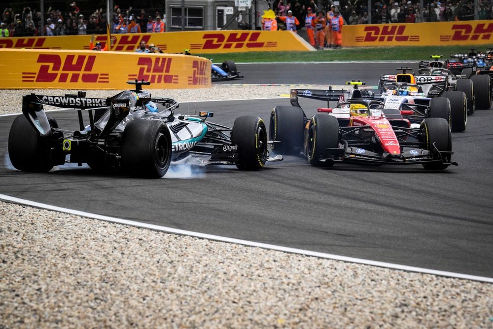 George Russell con Lewis Hamilton en el primer giro del GP de Bélgica